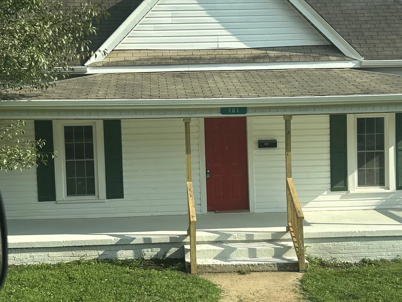Completed interior and exterior renovation with new kitchen cabinets and exterior railings.