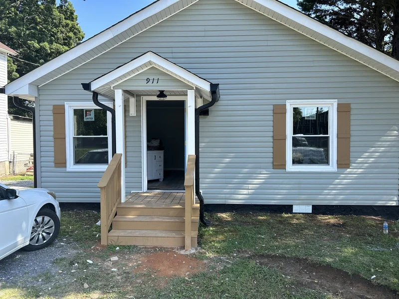 Rebuilt entry landing and railings replacing a rotted, cracked entry.